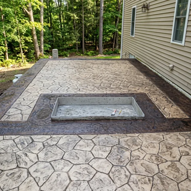 Decorative concrete patio surrounding an inset hot tub